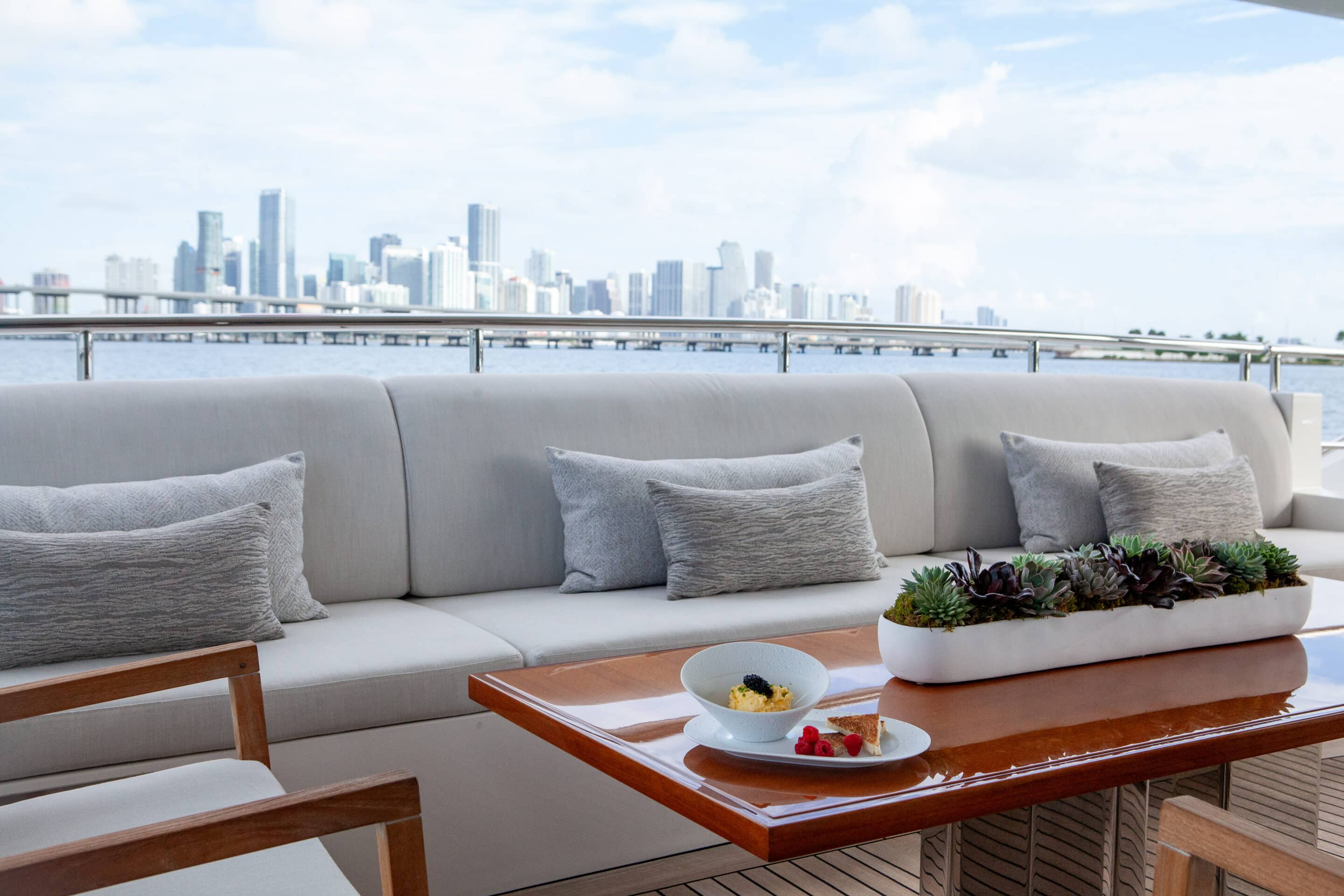 Caviar on table of Aft Deck with Miami City Skyline in the background.
